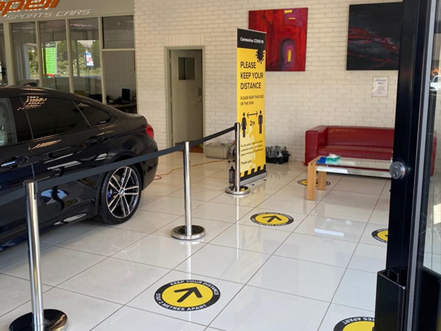 Social distancing floor graphics in Volvo car dealership